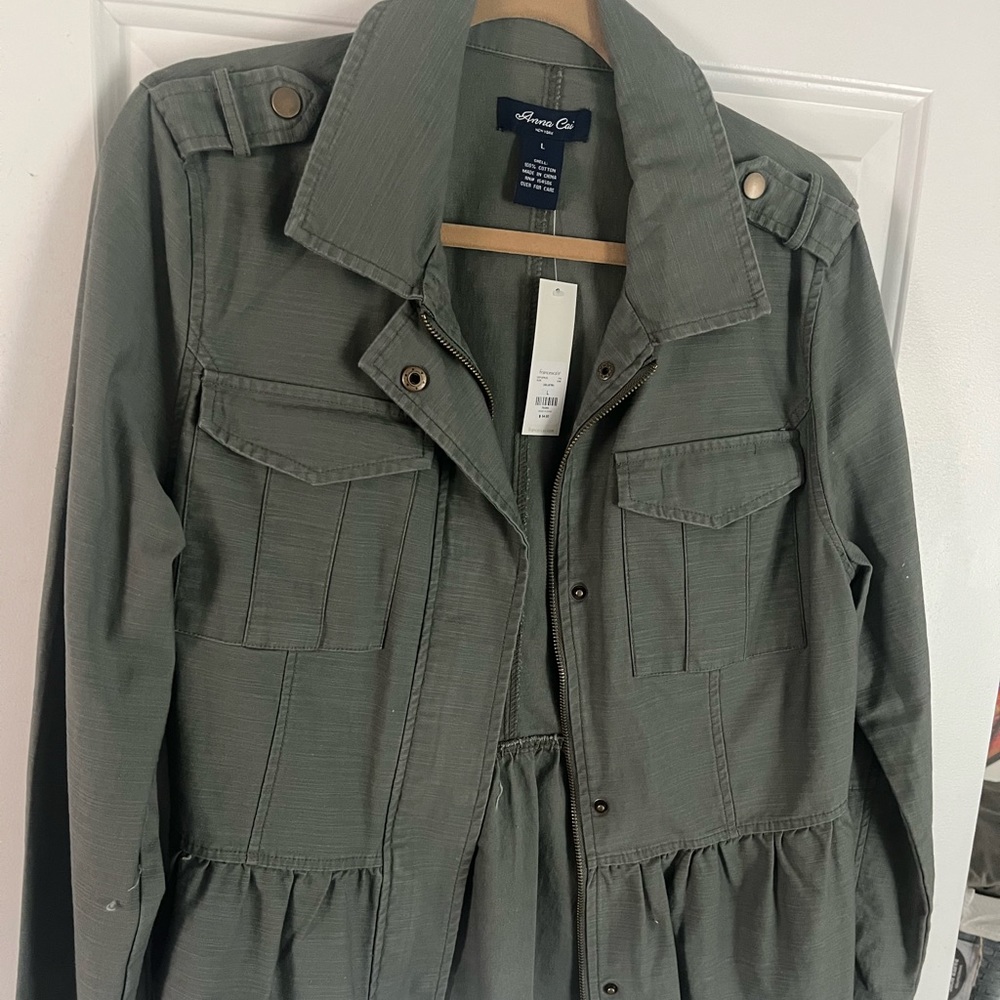 Brand new Anna Cai green jacket zips and flair at the bottom.